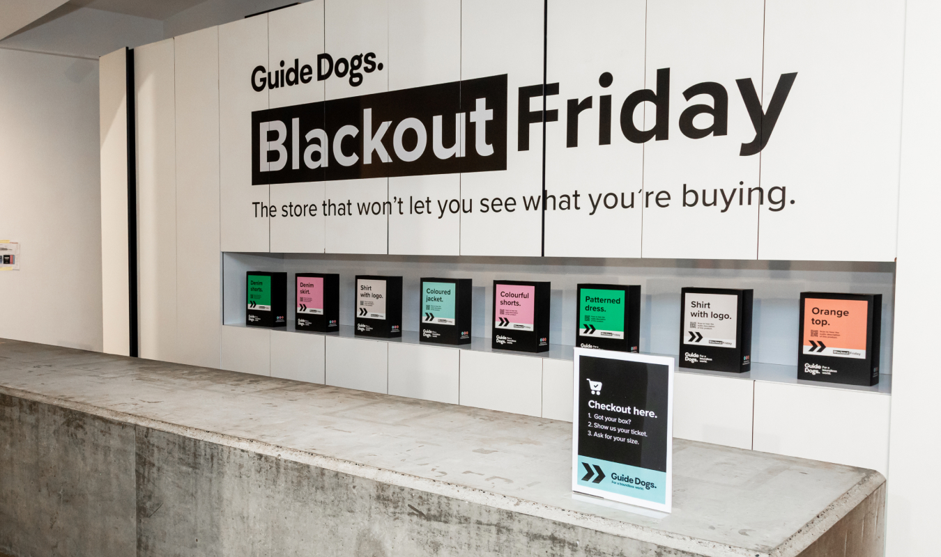 Image shows the Blackout Friday event set up. Mystery boxes along a shelf on the wall.